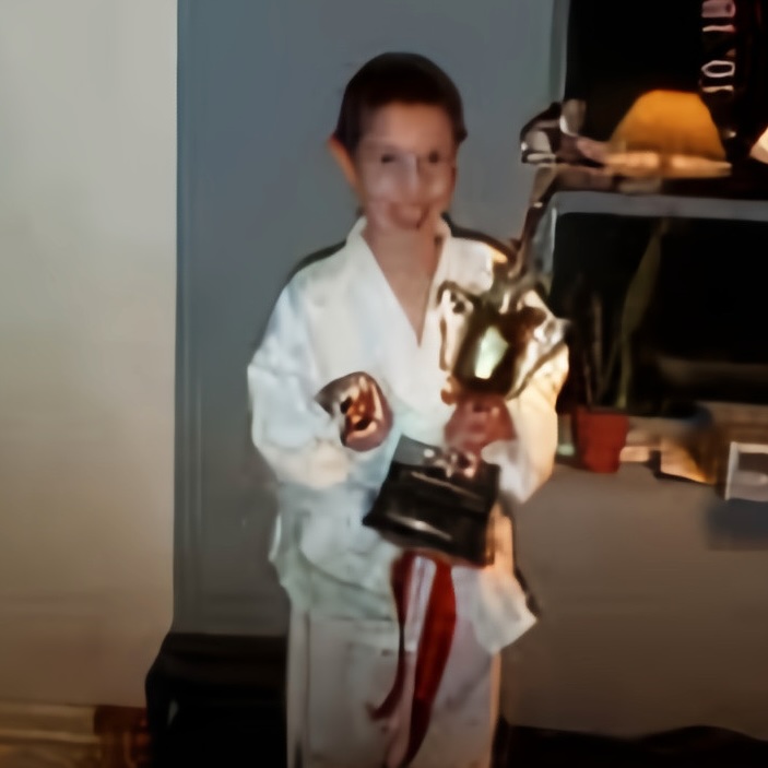 9-year-old me holding my TaeKwon-Do champioship trophy